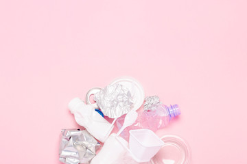Garbage collection, plastic and metal on a pink background. Concept stop plastic, recycling, separate collection of garbage. Flat lay, top view