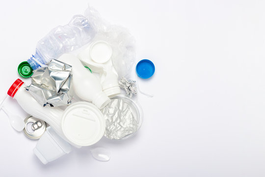 Garbage collection, plastic and metal on a white background. Concept stop plastic, recycling, separate collection of garbage. Flat lay, top view