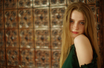 Fototapeta premium beautiful young blonde with long flowing hair and blue eyes in an old castle