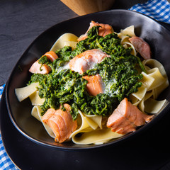 pappardelle pasta with creamed spinach and fried salmon