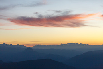 Picture of evening foggy mountain terrain with red sky