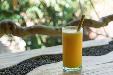 Zero waste concept with reuse bomboo straw, tropical delicious juice, Thai Bali seasonal, cool ice beverage for refreshing in summer on green nature bokeh background