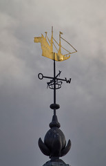 The Gold Sailing Ship topped weather vane at the Dutch Marine Museum at Den Helder in The Netherlands on one Spring Morning in May.