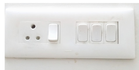 white switch pad on the wall