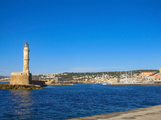 Photo of iconic old Venetian lighthouse in old harbour of Chania. Crete island, Greece