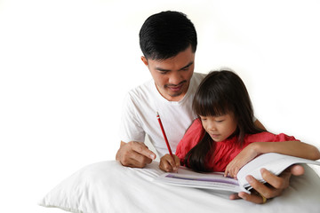 Asian father teaching his daughter's homework 