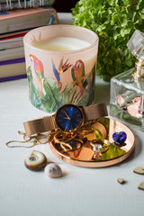 Candle and female accessories on a table. Beautiful things.