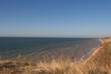 The waves of the sea roll up on a long shore