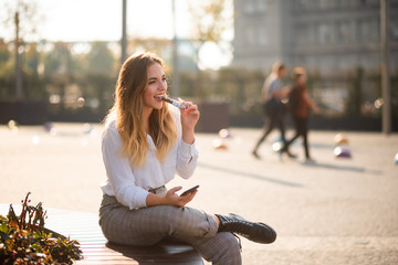 Happy girl having bite of energy bar, candid shot.