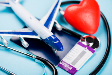 Travel insurance safe trip concept. Flights, toy plane and stethoscope