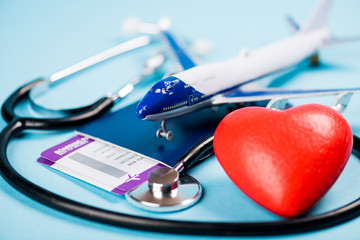 Travel insurance safe trip concept. Flights, toy plane and stethoscope