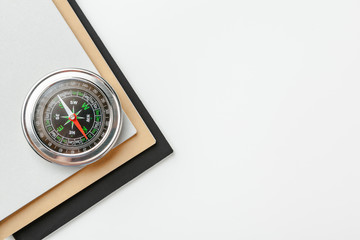 Close up of a compass on a white background