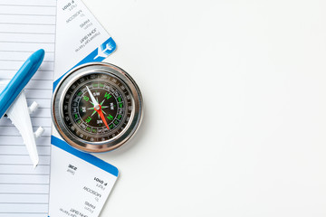 Time to Travel. Idea for tourism with flight tickets and compass on white