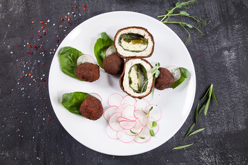 Close up Deep-fried chicken croquettes with spiced butter in white plate. Dark background. Food photo for menu or recipe. Tasty lunch. Chicken balls fast food