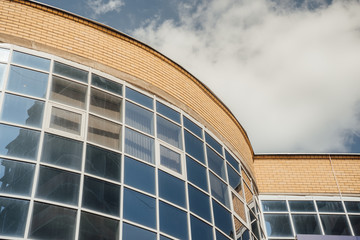 windows of modern office building. Modern architecture bank financial office tower building. clouds and bright blue sky reflected in the square mirrored windows of a modern commercial office building