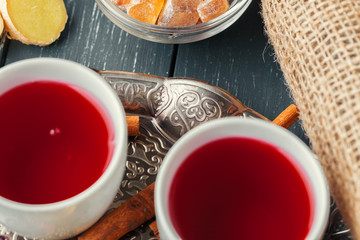 Cup of freshly brewed fruit and herbal tea, dark mood.Tea ceremony