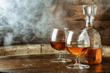 Cognac or whiskey in glasses on rustic backgrpund