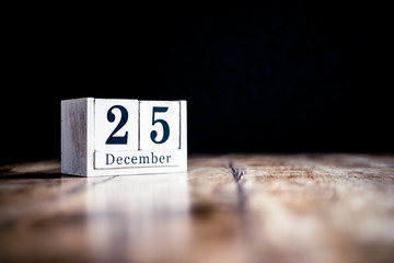 December 25th, 25 December, Twenty Fifth of December - White block calendar on vintage table - Date on dark background