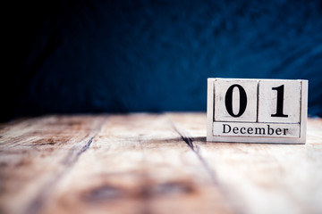 December 1st, 1 December, First of December - White block calendar on vintage table present date on dark background