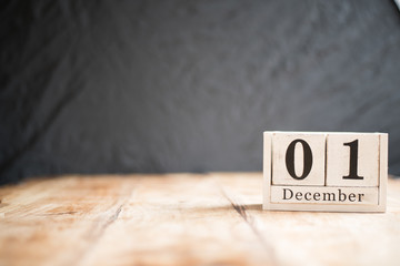 December 1st, 1 December, First of December - White block calendar on vintage table present date on dark background