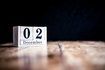 December 2nd, 2 December, Second of December - White block calendar on vintage table - Date on dark background