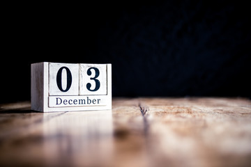 December 3rd, 3 December, Third of December - White block calendar on vintage table - Date on dark background