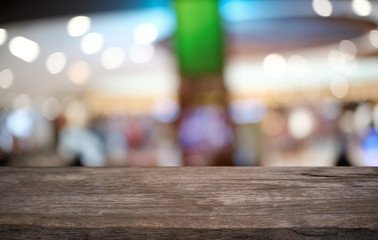 Empty dark wooden table in front of abstract blurred bokeh background of restaurant . can be used for display or montage your products.Mock up for space.