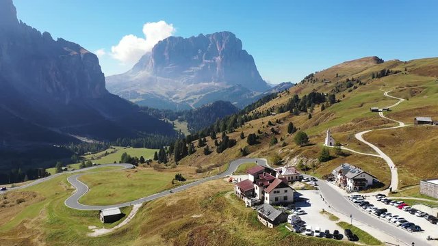 Beautiful view of the Dolomites at Gardena pass with the Cappella di San Maurizio and the green valley in South Tyrol, Italy. Gardena Pass in the Dolomites mountains Italy. Dolomites, Italy.