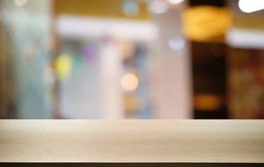 Empty dark wooden table in front of abstract blurred bokeh background of restaurant . can be used for display or montage your products.Mock up for space.