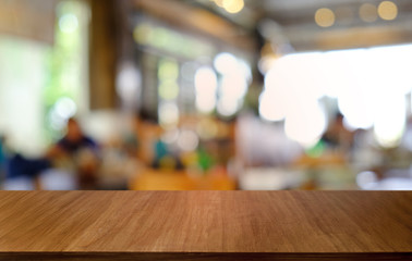 Empty dark wooden table in front of abstract blurred bokeh background of restaurant . can be used for display or montage your products.Mock up for space.