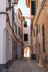 Fototapeta na wymiar Stone street of Ciutadella town in the evening, Ciutadella, Balearic islands, Spain