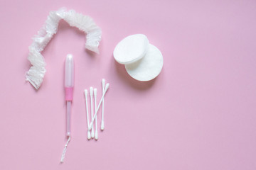Beautiful flatlay hygienic and women's accessories on pink with place for text. Hygiene, femininity, medicine, health care concept