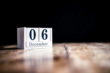 December 6th, 6 December, Sixth of December - White block calendar on vintage table - Date on dark background