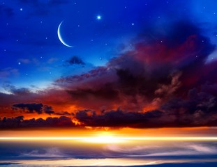 Beautiful dark fluffy cloudy sky with sun rays . Crescent moon with beautiful sunset background . Generous Ramadan . New moon. Prayer time. 