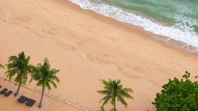 Top view of the tropical white sand beach sea front, tidal sea waves, ebbs and flows.