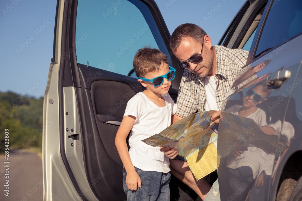 Canvas Prints Happy father and son standing near the car at the day time.