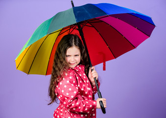 cheerful hipster child in positive mood. rain protection. Rainbow. autumn fashion. happy little girl with colorful umbrella. little girl in raincoat. Feeling the power of nature