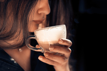 Young lady tasting Italian cappuccino