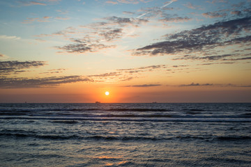 Scenic colorful sunset over the North Sea. View from the dutch coast in the town of Hoek van Holland.