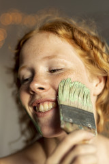 Close-up woman painting her face