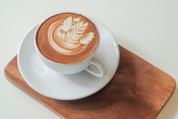 Coffee cup on table in cafe, on wooden