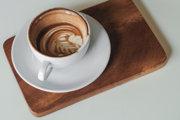 Coffee cup on table in cafe, on wooden