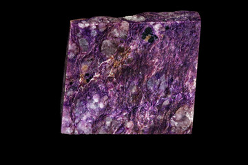 Macro of a stone Charoite mineral on a black background