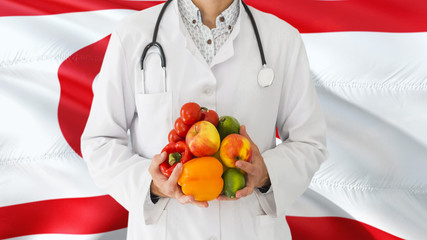 Doctor is holding fruits and vegetables in hands with Northern Cyprus flag background. National healthcare concept, medical theme.