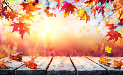 Naklejka na ściany i meble Autumn Backdrop - Wooden Table With Red Leaves