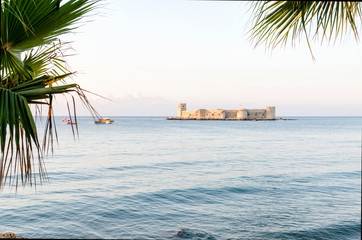 Maiden's castle, Kiz Kalesi with palm in Mediterranean Sea. Mersin Turkey
