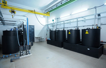 At the dosing systems hall of the water pumping station: sodium hypochlorite storage tanks and...