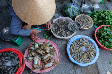 Hoi An, Vietnam - August 17: Fish sellers in the market on August 17, 2018 in Hoi An, Vietnam.