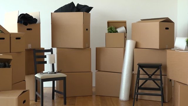 Cardboard boxes and chairs in the interior of an apartment