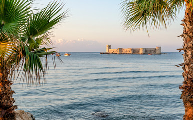 Maiden's castle, Kiz Kalesi with palm in Mediterranean Sea. Mersin Turkey
